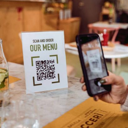 Friends in a restaurant scanning Online Food and Drinks menu